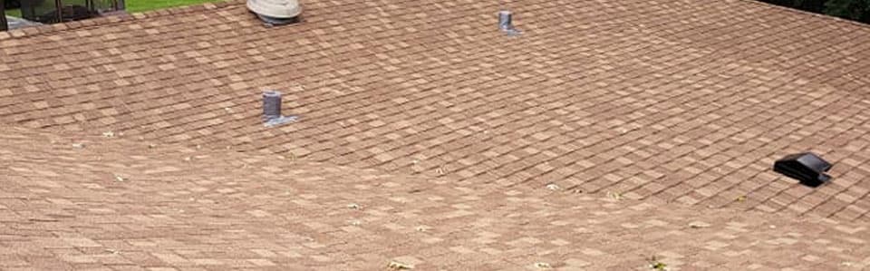 Residential roof with newly installed asphalt shingles
